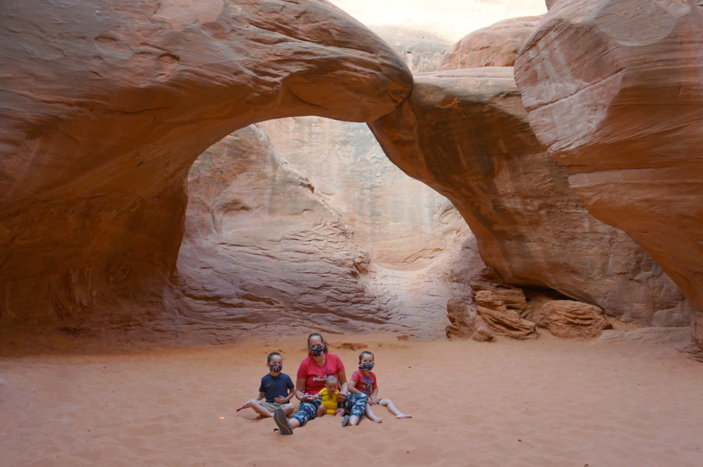 Sand Dune Arch is one of the most kid-friendly hikes in Arches National Park. Kids love playing in the sand - Exploring Through Life