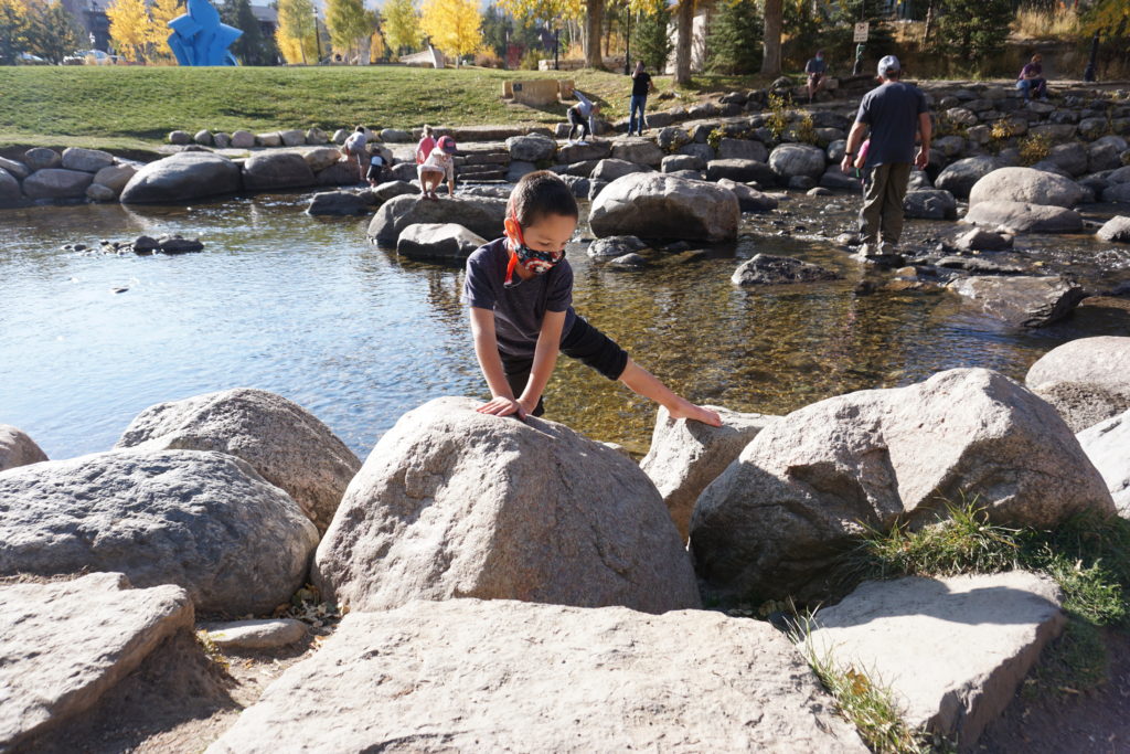 Kids will love climbing and playing in the Blue River in Breckenridge