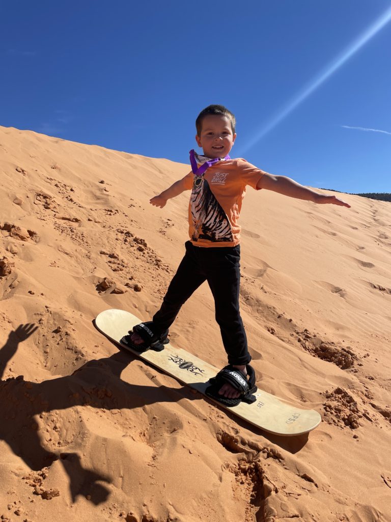 Even young kids can sandboard at Coral Pink Sand Dunes State Park in Utah. Rent a board for $25 at the park office and hit the slopes. - Exploring Through Life